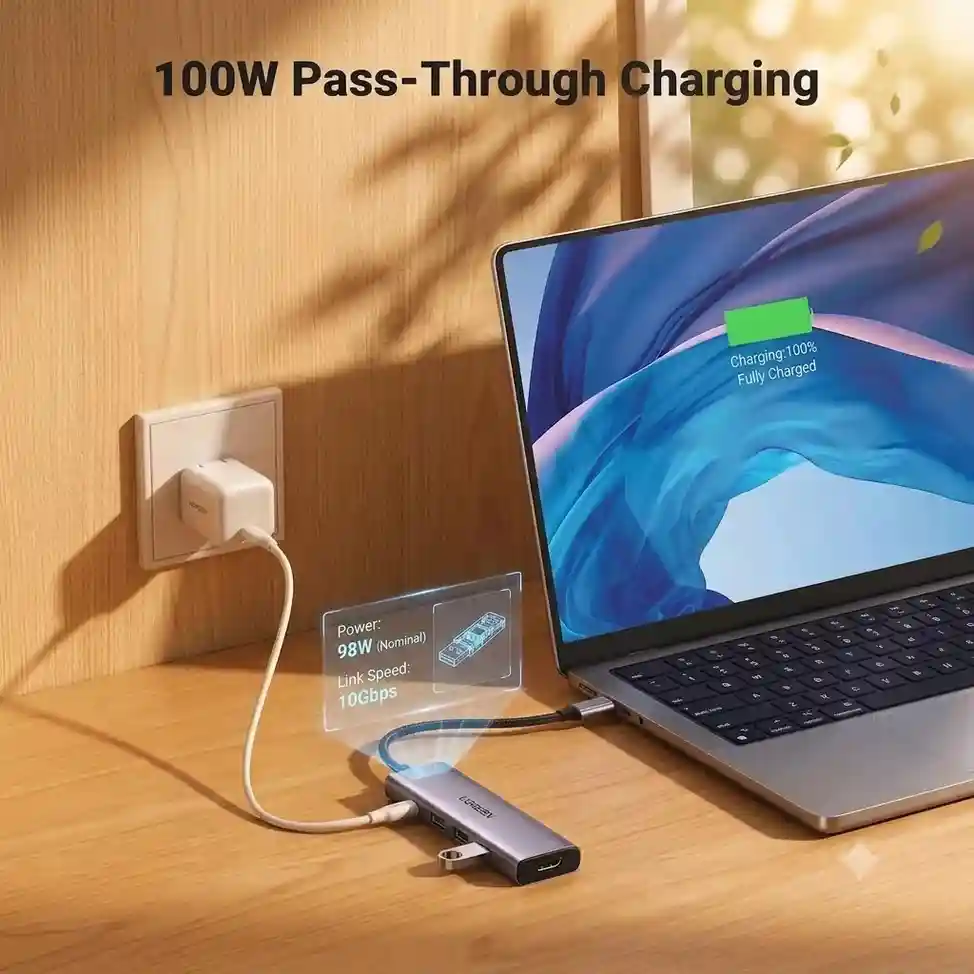 Laptop charging via UGREEN USB-C hub connected to a wall outlet.